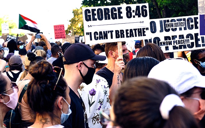 A sign at a Washington, D.C., protest over the death of George Floyd, who died after a Minneapolis police officer kneeled on his neck for 8 minutes, 46 seconds. Phoenix police said they will stop using a chokehold restraint that can cut off blood flow. (Photo by Geoff Livingston/Creative Commons)