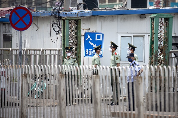 Paramilitary police stand guard on a street near the Xinfadi wholesale food market district in Beijing, Saturday, June 13, 2020. Beijing closed the city's largest wholesale food market Saturday after the discovery of seven cases of the new coronavirus in the previous two days. (Mark Schiefelbein/AP)