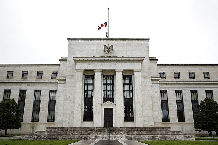 This May 22, 2020 photo shows the Federal Reserve building in Washington. The Federal Reserve said Monday, June 15, 2020 that it will begin purchasing corporate bonds as part of a previously-announced program to ensure companies can borrow through the bond market during the pandemic The program will purchase already-issued bonds on the open market and will seek to build a “broad and diversified” portfolio that will mimic a bond-market index. (AP Photo/Patrick Semansky)