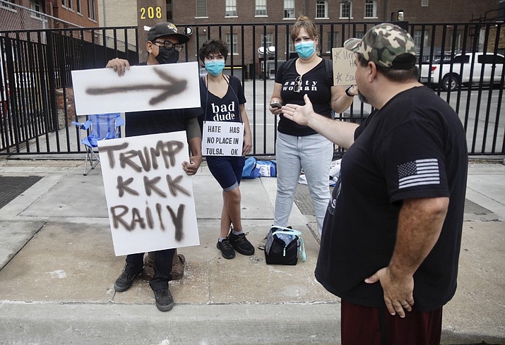 Daniel Pearl, right, a supporter of President Donald Trump, questions protesters as he waits to enter a safety barricade for Trump's campaign rally Saturday, June 20, 2020 in Tulsa, Oka. (Mike Simons/Tulsa World via AP)