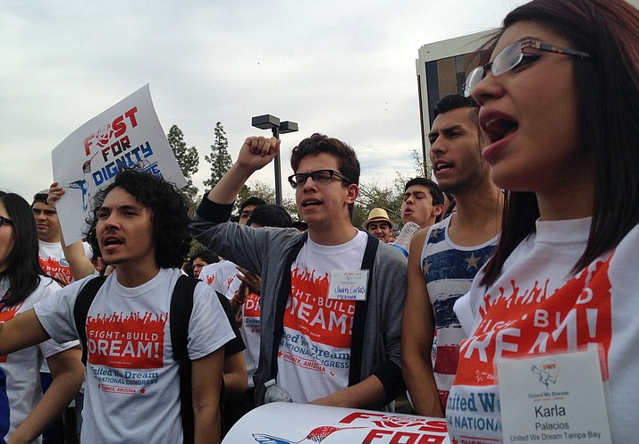Youth from United We Dream chant slogans calling for an end to deportations. outside the Immigration and Customs Enforcement (ICE) offices in downtown Phoenix, Saturday, Feb. 22, 2014. A 5-4 decision was issued by the U.S. Supreme Court to let young immigrants remain in this country. (Valerie Fernandez/AP, file)