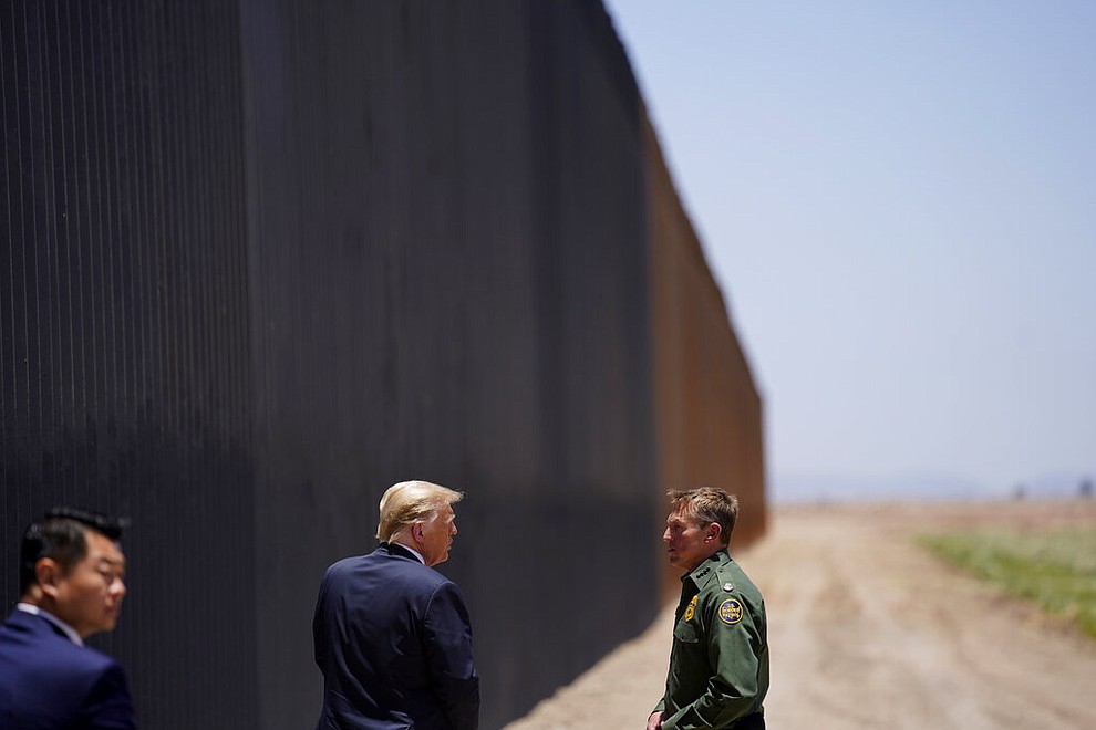 President Donald Trump speaks with Rodney Scott, the U.S. Border Patrol Chief, as he tours a section of the border wall, Tuesday, June 23, 2020, in San Luis, Ariz. (AP Photo/Evan Vucci)