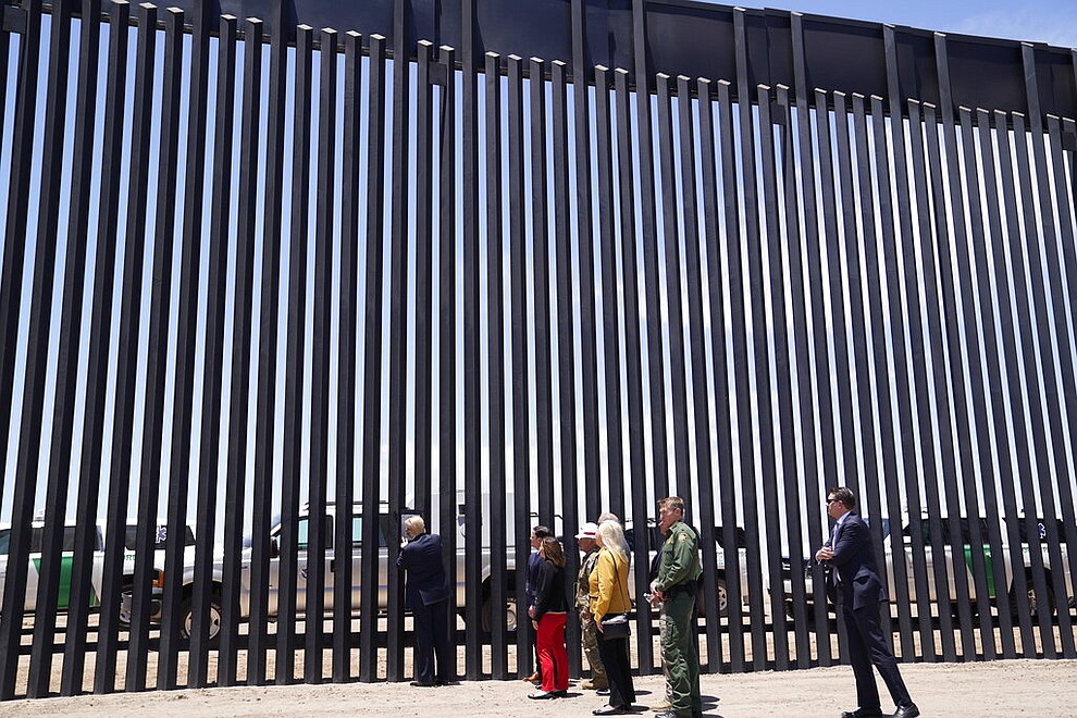 President Donald Trump signs a plaque as he tours a section of the border wall, Tuesday, June 23, 2020, in San Luis, Ariz. (AP Photo/Evan Vucci)