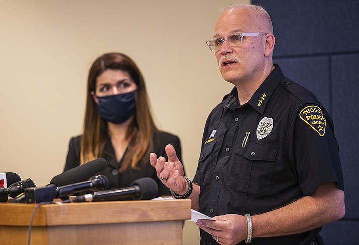 Tucson Police Chief Chris Magnus, right, speaks as Mayor Regina Romero listens during a press conference, Wednesday, June 24, 2020, in Tucson, Ariz. Chief Magnus offered his resignation after the death of a 27-year-old man who died while handcuffed and placed face-down, resulting in the resignation of three officers the chief said had violated department policy. The city council and city manager have to approve resignation. The city council and city manager have to approve resignation.The medical examiner’s office didn’t determine a manner of death but said Carlos Ingram-Lopez had died of sudden cardiac arrest while intoxicated by cocaine and physically restrained. (Josh Galemore/Arizona Daily Star via AP)