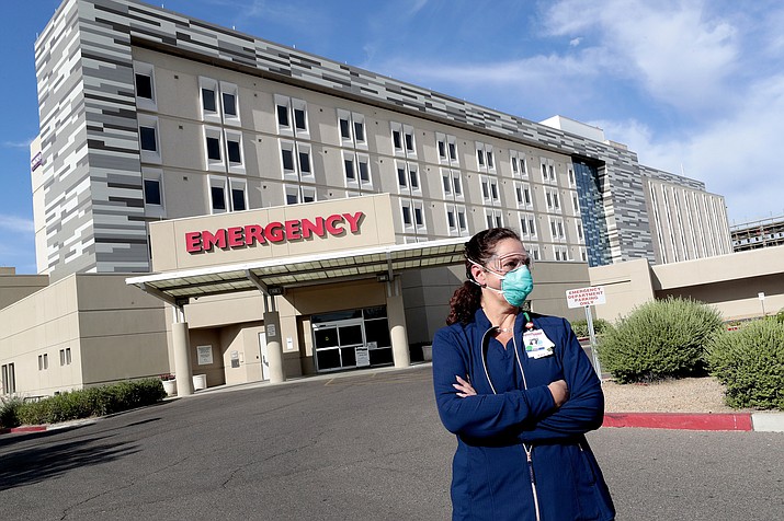 Caroline Maloney stands outside HonorHealth's Scottsdale Osborn Medical Center at the end of her overnight shift early Friday, June 26, 2020 in Scottsdale, Ariz. Arizona nurses and doctors find themselves on the frontline as the coronavirus rips through the state, making it one of the world's hot spots. (Matt York/AP)