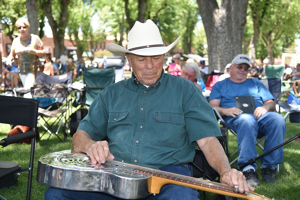 Mike Weatherford, 72, strums his steel lap guitar while Quick Sand Soup perfoms at the Prescott Bluegrass Festival at the Yavapai County Courthouse on Saturday afternoon, June 27, 2020. (Jesse Bertel/Courier)