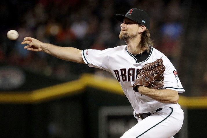 In this Sept. 24, 2019, file photo, Arizona Diamondbacks starting pitcher Mike Leake throws against the St. Louis Cardinals during the first inning of a baseball game, in Phoenix. Diamondbacks right-hander Mike Leake has opted out of the 2020 season due to concerns about the coronavirus. Diamondbacks general manager Mike Hazen did not elaborate on Leake’s decision during a Zoom call, but the pitcher’s agent issued a statement saying he made a personal decision not to play during the pandemic. (AP Photo/Matt York, File)