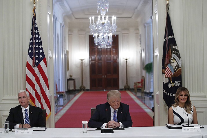 President Donald Trump, Vice President Mike Pence, left, and first lady Melania Trump, attend a "National Dialogue on Safely Reopening America's Schools," event in the East Room of the White House, Tuesday, July 7, 2020, in Washington. (Alex Brandon/AP)