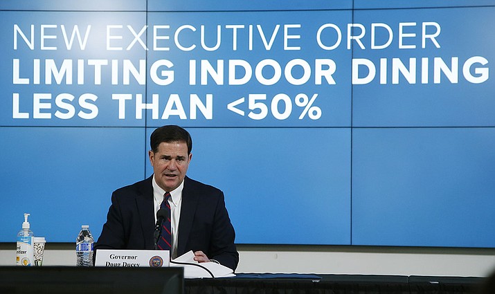 Arizona Republican Gov. Doug Ducey talks about an executive order as he speaks about the latest coronavirus information at a news conference, Thursday, July 9, 2020, in Phoenix. (AP Photo/Ross D. Franklin, Pool)