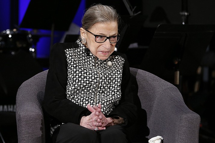 In this Dec. 17, 2019, file photo Supreme Court Justice Ruth Bader Ginsburg speaks with author Jeffrey Rosen at the National Constitution Center Americas Town Hall at the National Museum of Women in the Arts in Washington. Justice Ginsburg was being treated for a possible infection and was expected to stay in the hospital for a few days following a medical procedure, the Supreme Court said in a statement Tuesday.(AP Photo/Steve Helber, AP file)