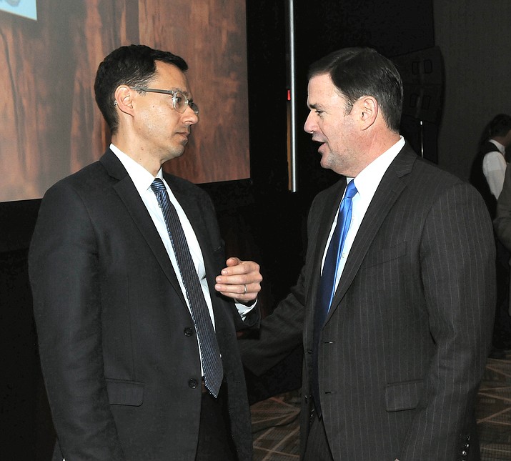 Gov. Doug Ducey, right, chats earlier this year with Glenn Hamer, president of the Arizona Chamber of Commerce and Industry, at a chamber-sponsored event. (Capitol Media Services, file photo)