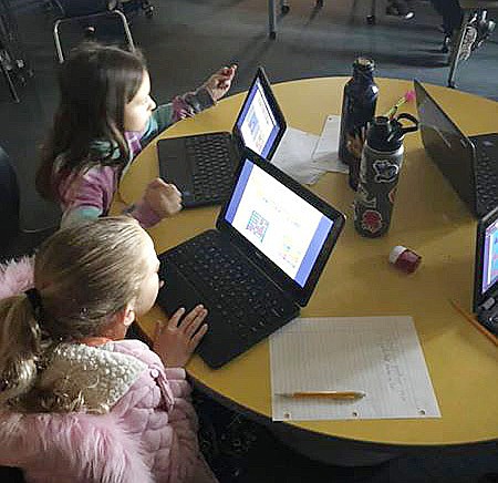 Two elementary-age girls in the Humboldt Unified School District work on computers in this undated photo. Virtual classrooms, as opposed to those in a brick-and-mortar setting, are what’s on tap for the time being. (HUSD archives/Courtesy)