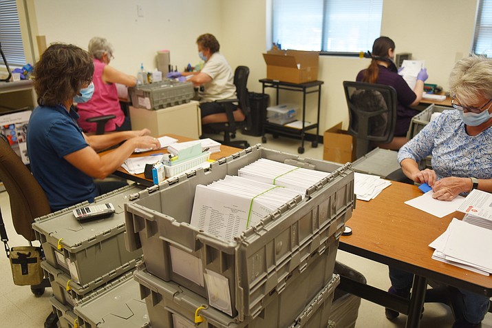 Yavapai County election officials separate signatures from ballots in the early counting process, at the Yavapai County Administrative Services building in Prescott, on Saturday, Aug. 1, 2020. (Jesse Bertel/Courier)