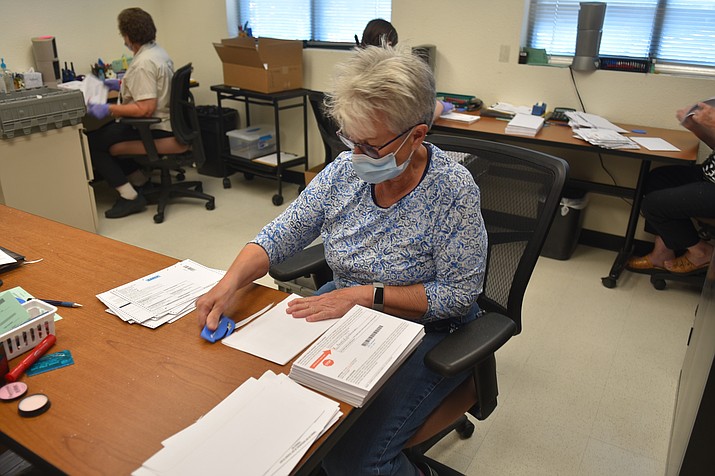 Election Official France Duran separates signature envelopes from mail-in ballots at the Yavapai County Administrative Services building in Prescott Saturday, Aug. 4, 2020. As of Wednesday, Aug. 5, as many as 20,000 ballots still need to be reviewed (Jesse Bertel/Courier)