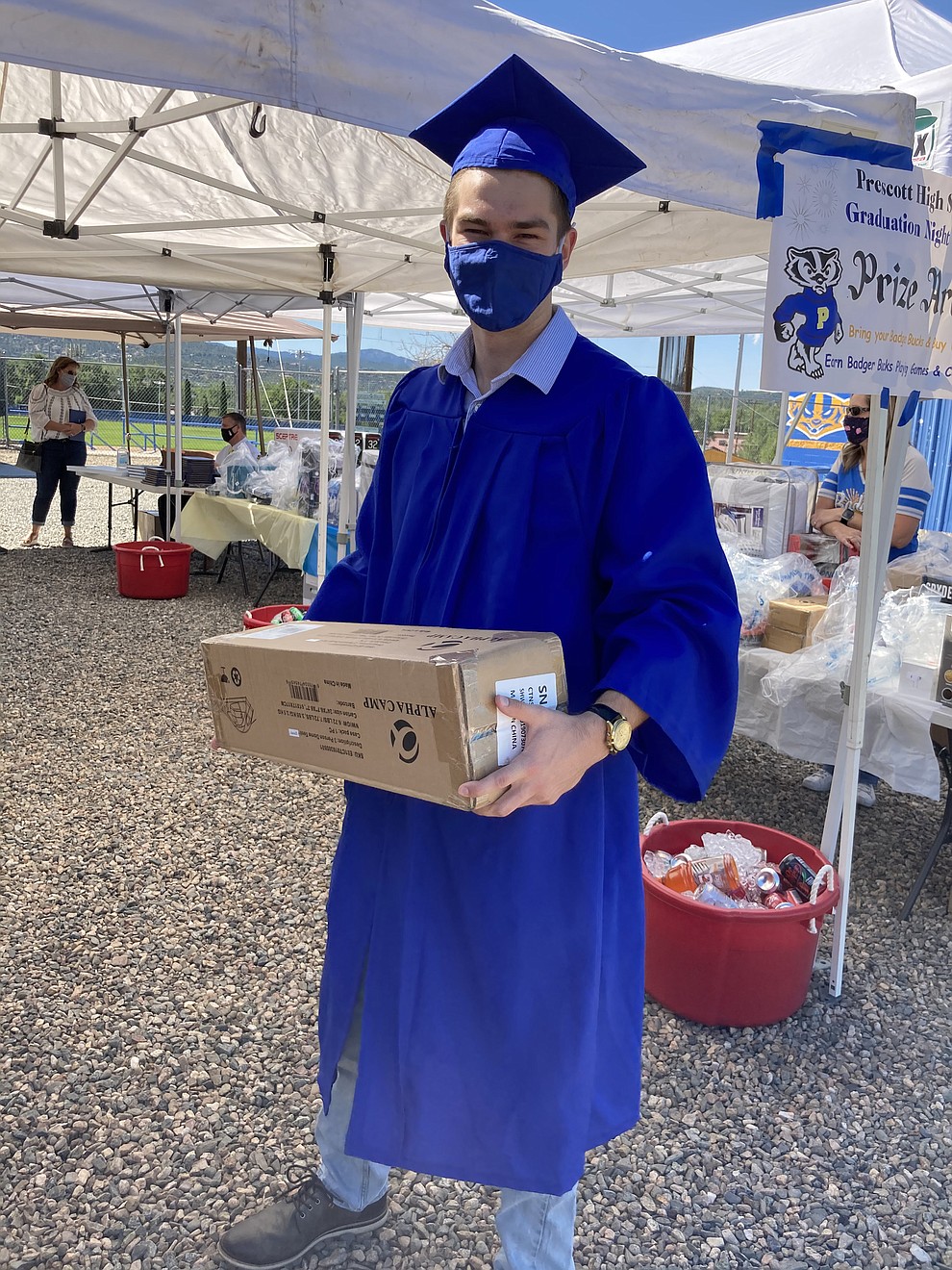 Prescott High School graduate Lucas Forray picks up a Grad Night gift at the school's graduation Saturday, Aug. 8, 2020. (Nanci Hutson/Courier)