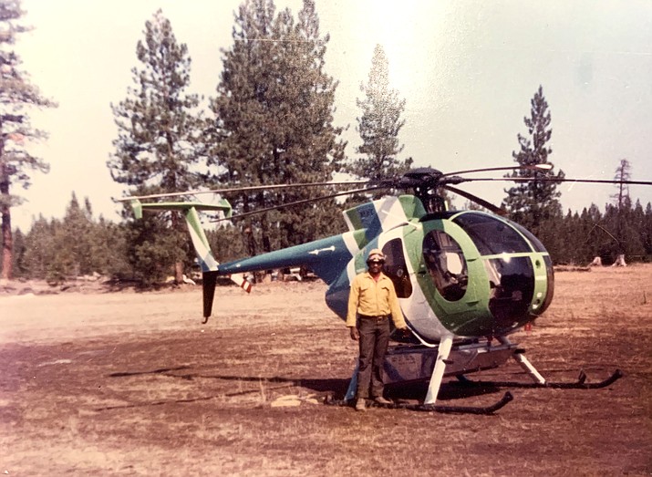 Edgar Brown stands in front of a Loach H-6 model 500 Helicopter in 1972. Brown spent most of his adult life working for the U.S. Forest Service. (Submitted photo)