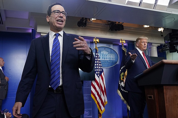 President Donald Trump listens as Treasury Secretary Steven Mnuchin speaks at a news conference in the James Brady Press Briefing Room at the White House, Monday, Aug. 10, 2020, in Washington. (Andrew Harnik/AP)