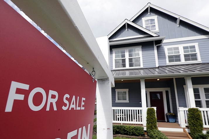 In this April 1, 2020 photo, a “For Sale” sign stands in front of a home that is in the process of being sold in Monroe, Wash., outside of Seattle. U.S. home sales rose a record-breaking 24.7% in July, extending last month’s rebound after the coronavirus pandemic all but froze the housing market this spring, the National Association of Realtors said Friday, Aug. 21, 2020. (Elaine Thompson/AP, file)