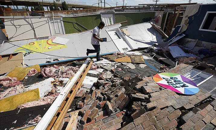 Benjamin Luna helps recover items from the children's wing of the First Pentecostal Church that was destroyed by Hurricane Laura, Thursday, Aug. 27, 2020, in Orange, Texas. (Eric Gay/AP)