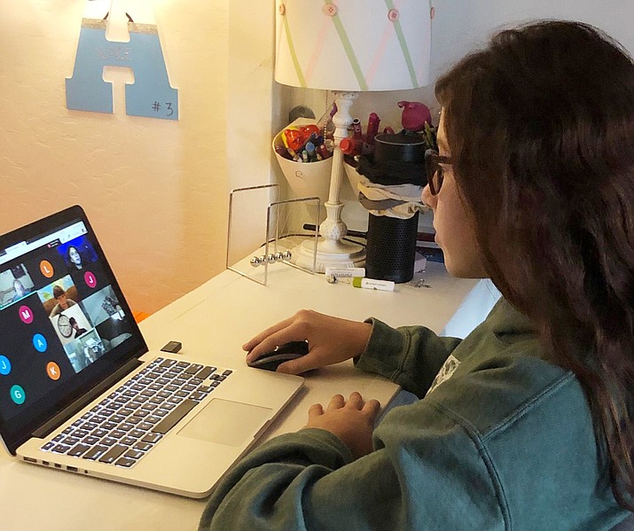 Ava Lee, a Glassford Hill Middle School eighth-grader, tunes into her remote learning lesson online from the privacy of her bedroom desk. (HUSD/Courtesy)
