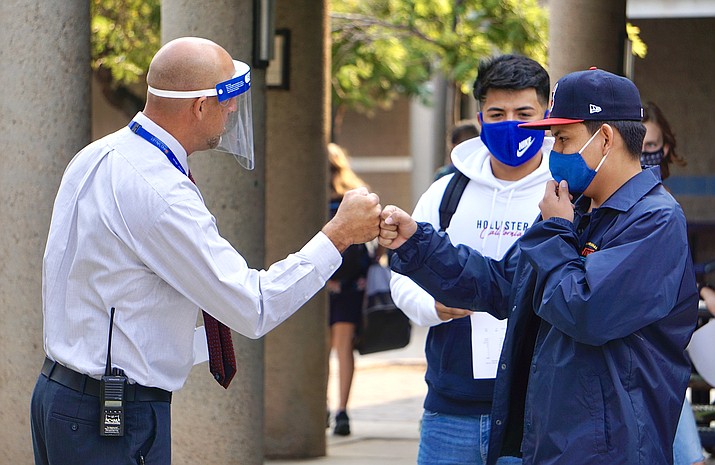 Chino Valley High School assistant principal Brian Pereira greets students as they make their way to class during Chino Valley Unified Schools District’s first day of hybrid instruction on Tuesday, Sept. 8, 2020. (Aaron Valdez/Courier)
