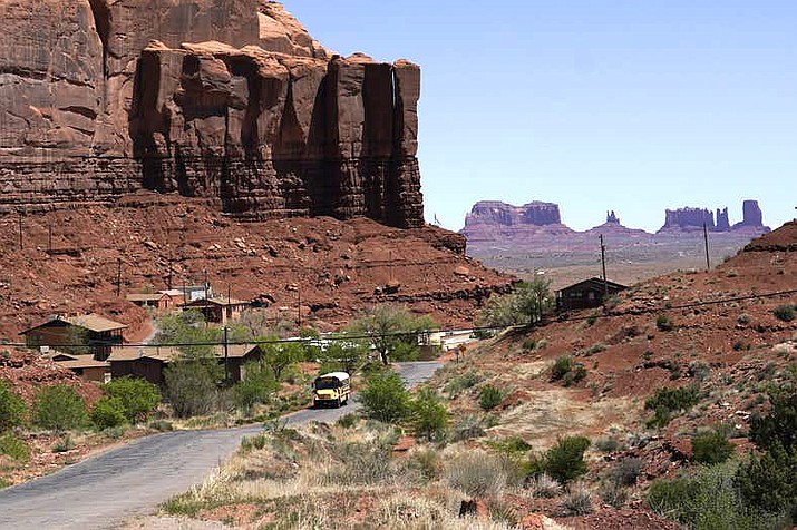 In this April 27 photo, a school bus travels through Oljato-Monument Valley, Utah, on the Navajo Nation. (AP Photo/Carolyn Kaster, File)
