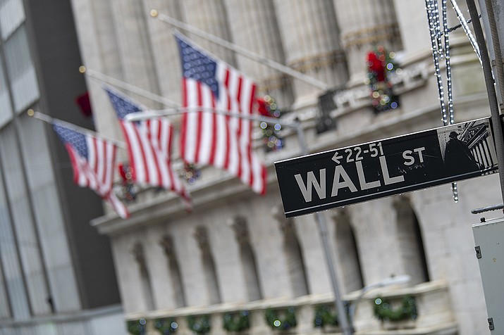 In this Jan. 3, 2020 file photo, the Wall St. street sign is framed by American flags flying outside the New York Stock Exchange in New York. Stocks are falling early on Wall Street Thursday, Sept. 17, as the late selling from the previous day carries over. (Mary Altaffer, AP File)