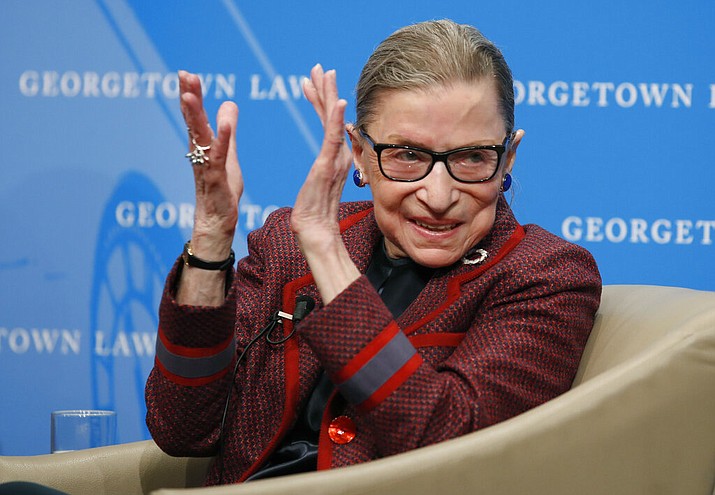 In this April 6, 2018, file photo, Supreme Court Justice Ruth Bader Ginsburg applauds after a performance in her honor after she spoke about her life and work during a discussion at Georgetown Law School in Washington. The Supreme Court says Ginsburg has died of metastatic pancreatic cancer at age 87. (AP Photo/Alex Brandon, File)