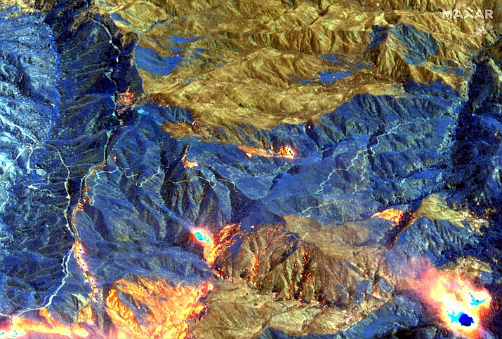 A shortwave infrared satellite image provided by Maxar Technologies shows an area of the Bobcat Fire burning northeast of Los Angeles Sept. 21. The Bobcat Fire has burned for more than two weeks and was still threatening more than 1,000 homes after scorching its way through brush and timber down into the Mojave Desert. It's one of dozens of other major blazes across the West. (Maxar Technologies via AP)