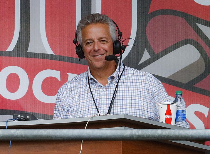 In this Sept. 25, 2019, file photo, Cincinnati Reds broadcaster Thom Brennaman sits in a special outside booth before the Reds' baseball game against the Milwaukee Brewers in Cincinnati. The Reds say Brennaman has resigned following his use of an anti-gay slur on air in August. (John Minchillo, AP File)
