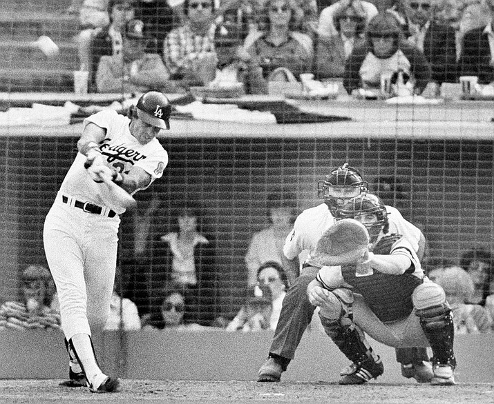In this Oct. 24, 1981, file photo, Los Angeles Dodgers batter Jay Johnstone hits a two-run home run in the sixth inning off New York Yankees relief pitcher Ron Davis in the World Series in Los Angeles. Johnstone, who won World Series championships as a versatile outfielder with the New York Yankees and Los Angeles Dodgers while being baseball’s merry prankster, died Saturday, Sept. 26, of complications from COVID-19 at a nursing home in Granada Hills, Calif., his daughter Mary Jayne Sarah Johnstone said Monday, Sept. 28, 2020. He was 74. He also from dementia in recent years, his daughter said. (AP Photo/File)