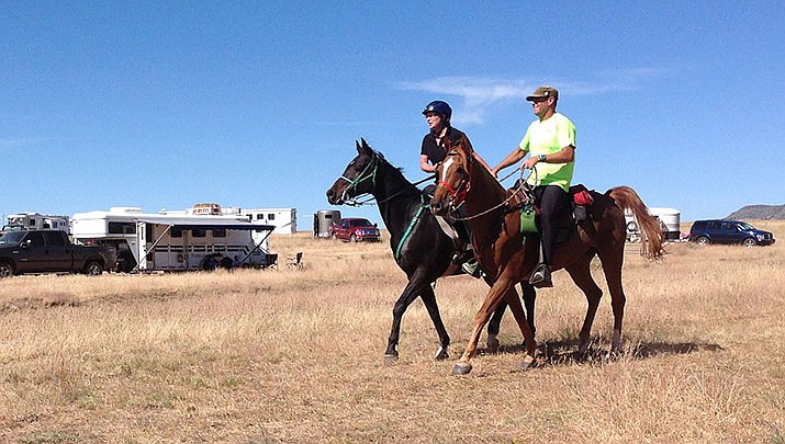 Horseback riders Troy Eckard and Dayna Weary cross the finish line together in the 2014 Man Against Horse Race near Mingus Mountain outside of Prescott Valley. The 2020 Man Against Horse Race will take place Saturday morning, Oct. 10, with the 12-, 25- and 50-mile ultra-run and endurance ride. (Courier file photo)