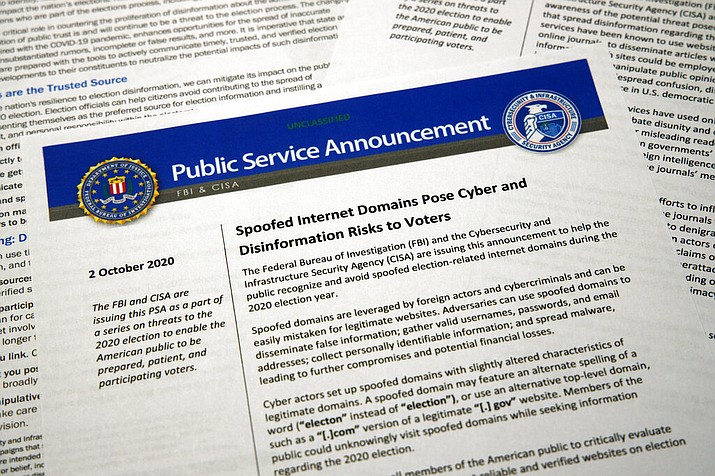 A public service announcement from the FBI and the Department of Homeland Security cybersecurity agency is photographed Tuesday, Oct. 6, 2020. The government agencies have issued a series of advisories in recent weeks aimed at warning voters about problems that could surface in the election — as well as steps Americans can take to counter the foreign interference threat. (AP Photo/Jon Elswick)