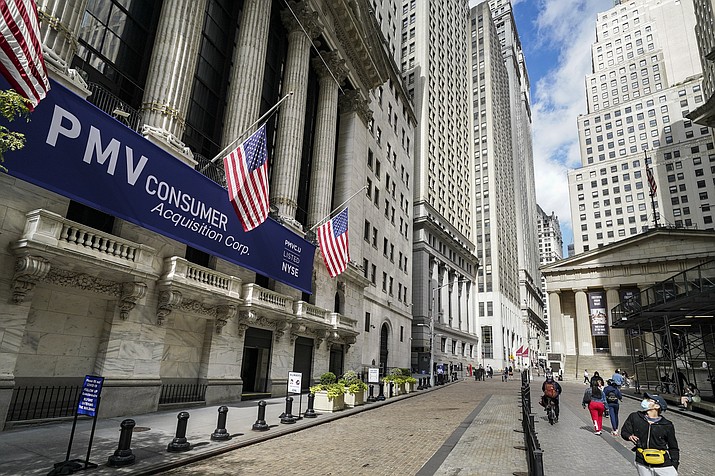 Pedestrians pass the New York Stock Exchange, Friday, Oct. 2, 2020, in New York. (John Minchillo/AP)