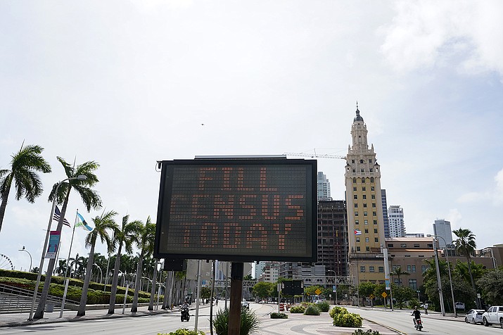 In this Oct. 5, 2020, file photo, a flashing sign near the iconic "Freedom Tower," advises people to fill out their census forms in downtown Miami. The Supreme Court’s decision to allow the Trump administration to end the 2020 census was another case of whiplash for the census, which has faced stops from the pandemic, natural disasters and court rulings. (AP Photo/Wilfredo Lee)
