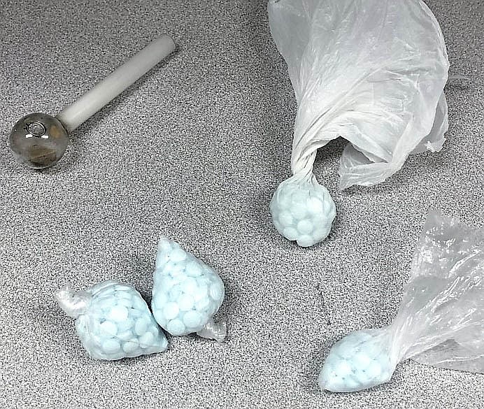 The deputy recovered a drug pipe with methamphetamine residue. A search of the area just outside the passenger window where it appeared Marshall had tossed something, revealed four separate plastic baggies each containing numerous blue pills marked M30, presumptive for fentanyl. YCSO photo