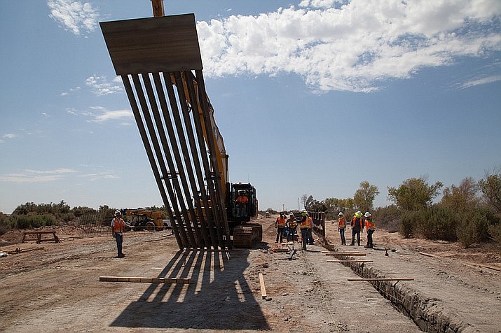 An Army Corps of Engineers unit installs a section of border wall near Yuma in September 2019. Courts have rejected President Donald Trump’s claim that he could shift Defense Department and other funds to the wall, but now the Supreme Court has agreed to review those rulings. (Photo by Vincent Mouzon/Army Corp of Engineers)