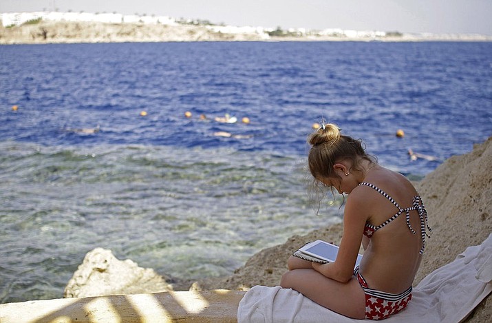 In this 2015 file photo, a Russian tourist sits by the water in the resort city of Sharm el-Sheikh, south Sinai, Egypt. A young Ukrainian tourist lost an arm and an Egyptian tour guide a leg in a rare shark attack at the end of October off Egypt’s Red Sea resort of Sharm El-Sheikh, officials said last Tuesday. (Ahmed Abd El-Latif/Asoociated Press. file)