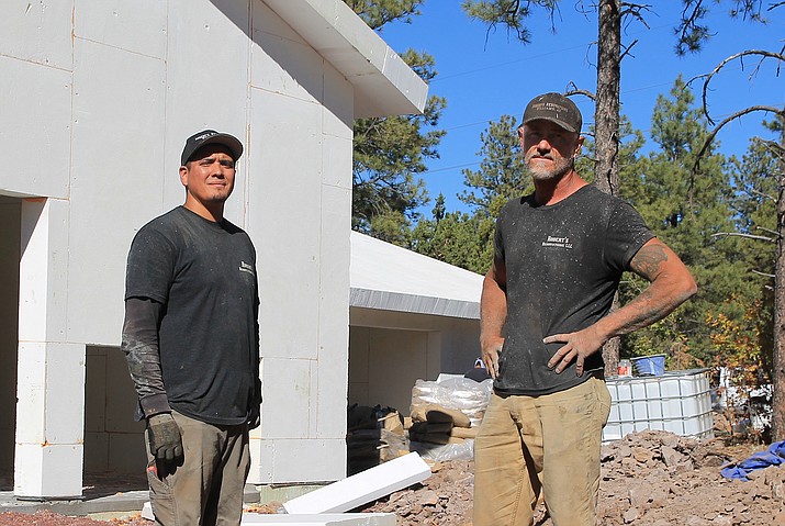 General contractor Robert Case (right), of Robert’s Restorations, and construction worker Joe Gabaldon work on a foam constructed home in Williams. (Wendy Howell/WGCN)