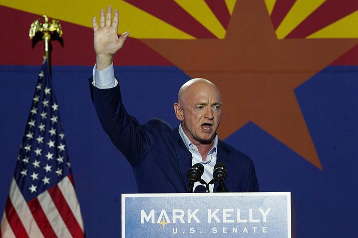 Mark Kelly, Arizona Democratic candidate for U.S. Senate, waves to supporters as he speaks during an election night event Tuesday, Nov. 3, 2020 in Tucson, Ariz. (AP Photo/Ross D. Franklin)