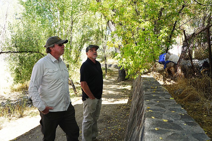 Prescott Trails and Natural Open Space Coordinator Chris Hosking, left, and Recreation Services Director Joe Baynes, right, discuss improvements that are planned to the Granite Creek Corridor through downtown Prescott. The two walked the route in early October, 2020. (Cindy Barks/Courier file)