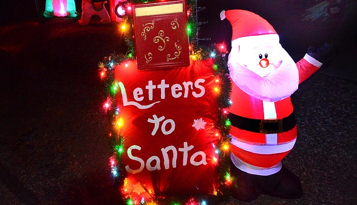 Santa’s elves Matt and Tony Meili-Petzoldt have placed a mailbox to Santa in front of their Cottonwood home on South Desert Flower Circle. VVN/Vyto Starinskas