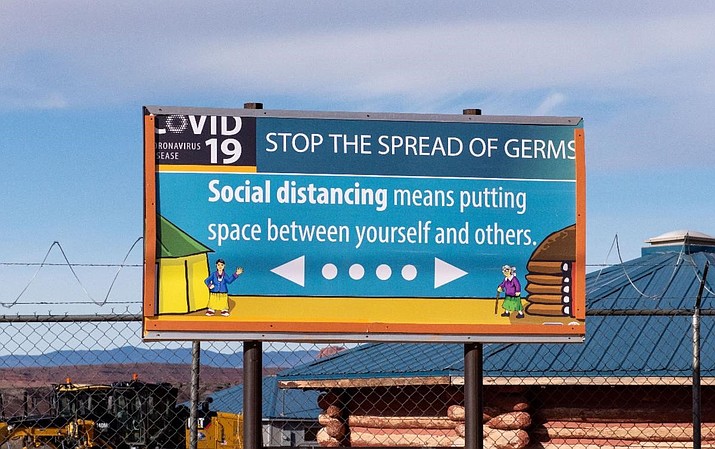 Public health messages across the Navajo Nation emphasize social distancing, as seen on this community billboard. (Photo courtesy of the Navajo Nation Council)