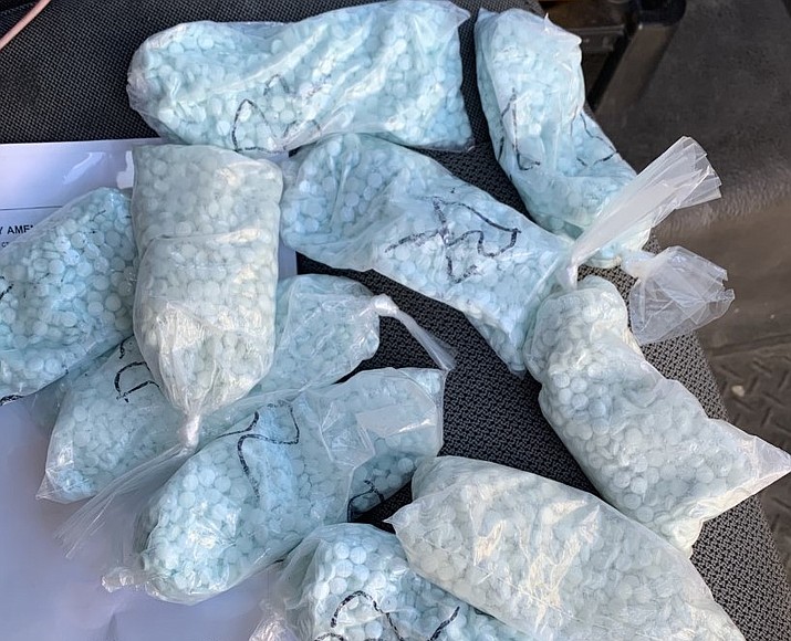 Inside the cab of a truck, a K9 deputy found a fast-food bag that contained two separate bags, which held 10 individual baggies of blue M30 pills, presumptive for fentanyl. The arrests were the result of the Yavapai County Sheriff's Office patrol efforts. (YCSO/Courtesy)