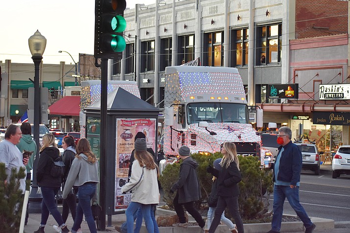 Trucks decorated with lights drive around the busy courthouse plaza in Prescott shortly before the Saturday, Dec. 5, 2020, holiday lighting ceremony.  The city, the Prescott Chamber, Prescott Downtown Partnership, and Acker Night Committee jointly decided to cancel their annual holiday events this year due to the ongoing concerns about rapidly increasing COVID-19 numbers. (Courier photo)