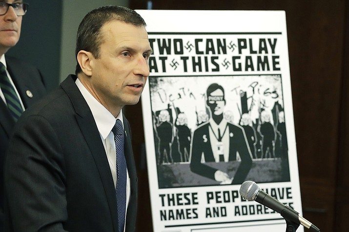 Raymond Duda, FBI Special Agent in Charge in Seattle, speaks as he stands next to a poster that was mailed earlier in the year to the home of Chris Ingalls, an investigative reporter with KING-TV in Seattle Feb. 26, 2020, during a news conference in Seattle. Johnny Roman Garza, 21, of Arizona, was sentenced to 16 months in federal prison Wednesday, Dec. 9, for his role in the group. (Ted S. Warren/AP, file)