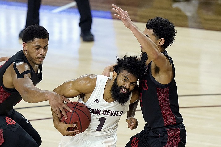 Arizona State guard Remy Martin (1) tries to drive past San Diego State forward Matt Mitchell, left, and guard Trey Pulliam, right, during the first half of a college basketball game Thursday, Dec. 10, 2020, in Tempe, Ariz. (Ross D. Franklin/AP)