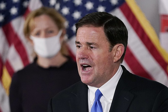 Gov. Doug Ducey and Arizona Department of Health Services Director Dr. Cara Christ are shown at a news conference Dec. 2, 2020, in Phoenix. Half of the counties in Arizona are seeing “substantial” spread of COVID-19, state health officials said while reporting new cases and deaths throughout the state. (Ross D. Franklin/AP, file)