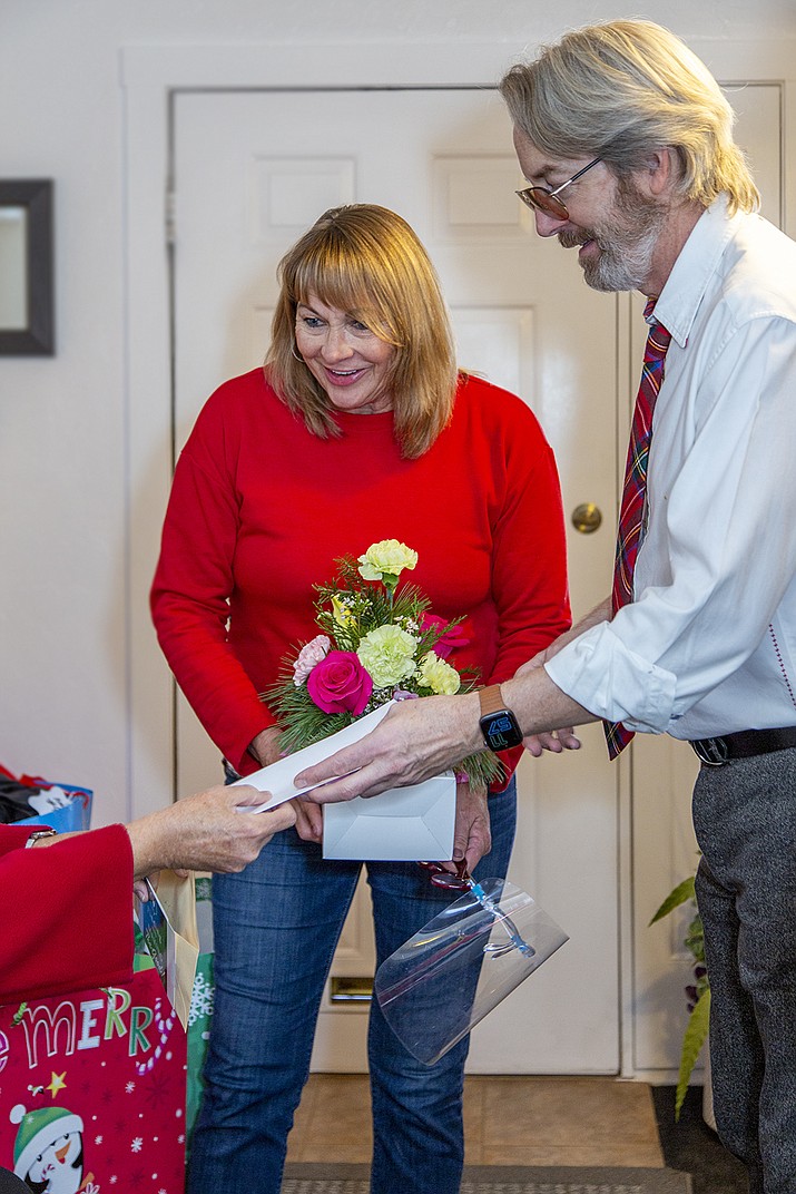 Rhonda Babbitt and her colleague, Phil, right, are recognized with a bouquet from Allan’s Flowers and a gift certificate to Triple Creek Restaurant. (Andrew McQuality/Courtesy)