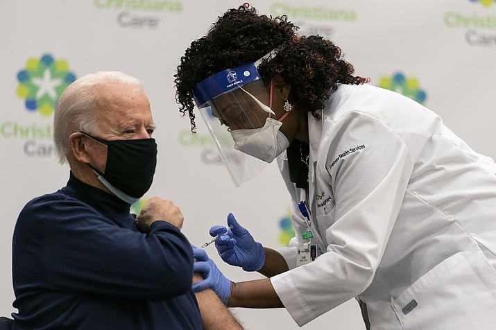 President-elect Joe Biden receives his first dose of the coronavirus vaccine from Nurse partitioner Tabe Mase at Christiana Hospital in Newark Del., Monday, Dec. 21, 2020, from nurse practitioner Tabe Mase. (Carolyn Kaster/AP)